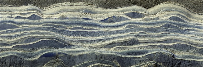 Imagen compuesta que muestra capas alternas de hielo y arena en un área donde están expuestos en la superficie de Marte.