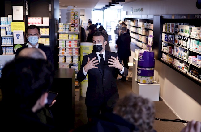El presidente francés Emmanuel Macron (d) y el ministro de Sanidad Olivier Véran (I) durante su visita a una farmacia de Valenciennes, Francia. EFE