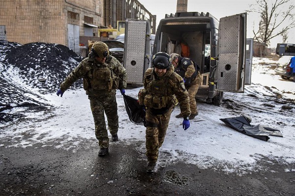 Miembros de la unidad de policía White Angels trasladan los restos de una persona que murió durante un bombardeo en Bakhmut, en el este de Ucrania.