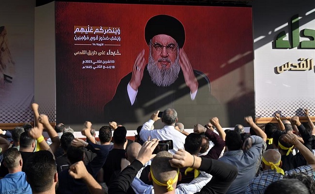 Sus partidarios siguen el discurso del líder de Hezbollah, Hassan Nasrallah, mostrado en una pantalla en un suburbio del sur de Beirut, Líbano.
