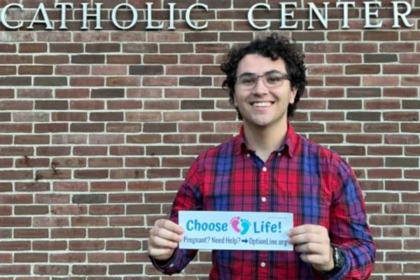 Gabriel Dionisi, un estudiante universitario de 22 años que crea pegatinas para coches en defensa de la vida con el objetivo de difundir el mensaje provida y concienciar a los demás, muestra una de sus obras. | Crédito: Gabriel Dionisi/AciPrensa