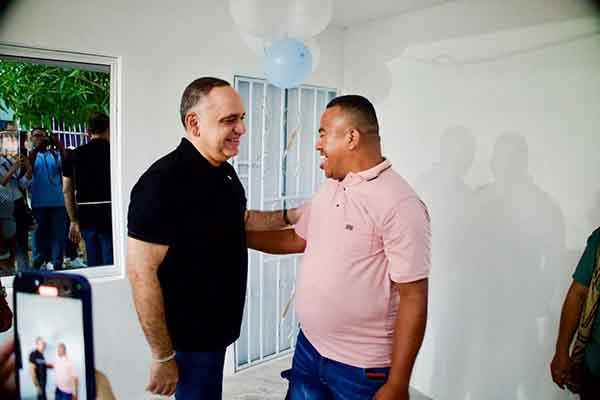 Carlos Pinedo, alcalde de Santa Marta junto a Luis Miguel Colón Castillo, el joven con discapacidad recibiendo la remodelación de su casa. Foto Alcaldía 