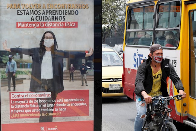 Carteles que promueven el distanciamiento físico y el uso de mascarillas como parte de la nueva normalidad del país se ven, 6 de octubre del 2020, en las calles de Bogotá. EFE