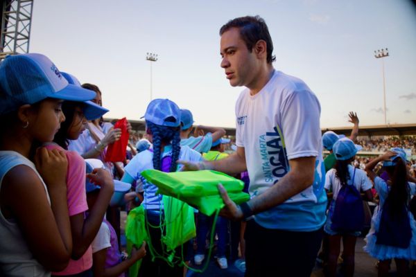 El secretario de Promoción Social, David Farelo, entregando kits escolares a niños. Foto Alcaldía de Santa Marta