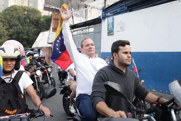 El opositor Juan Pablo Guanipa (c), cercano a la líder María Corina Machado, sostiene una bandera de Venezuela durante una caravana tras ser excarcelado este domingo, en Caracas (Venezuela). Guanipa abogó por la reconciliación en Venezuela, pero, subrayó, "con la verdad", una declaración que hizo horas después de ser excarcelado luego de estar detenido desde mayo de 2025. EFE/ Ronald Peña R
