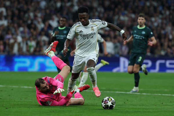 El delantero brasileño del Real Madrid, Vinicius Junior (d), intenta superar al guardameta italiano del Manchester City, Gianluigi Donnarumma, durante el encuentro correspondiente a la ida de los octavos de final de la Liga de Campeones que Real Madrid y Manchester City disputan este miércoles en el estadio Santiago Bernabéu, en Madrid. EFE/Kiko Huesca.