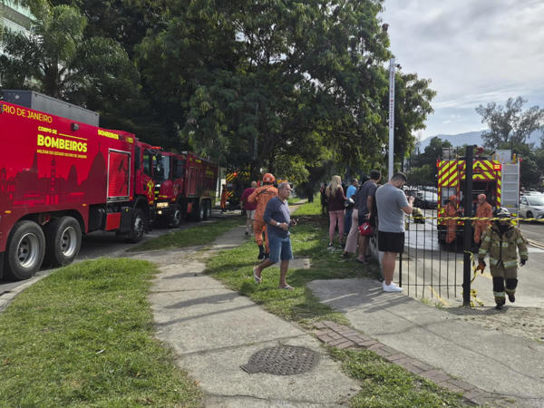 Fotografía cedida este domingo por Roberta Durço que muestra bomberos recorriendo la zona donde ocurrió el accidente de dos helicópteros que colisionaron en el barrio Recreio dos Bandeirantes, en Río de Janeiro (Brasil). La colisión de dos helicópteros esta mañana deja un saldo de al menos seis personas fallecidas, según informaron fuentes oficiales. EFE/ Roberta Durço