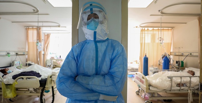 Una enfermera descansa en un pasillo cerca de pacientes infectados por el coronavirus SARS-CoV-2 en un hospital de Wuhan, capital y epicentro del brote en China, este domingo. EFE/Stringer