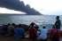 Personas observan el humo ocasionado por una nueva explosión en la base de contenedores en la zona industrial de la bahía de Matanzas.